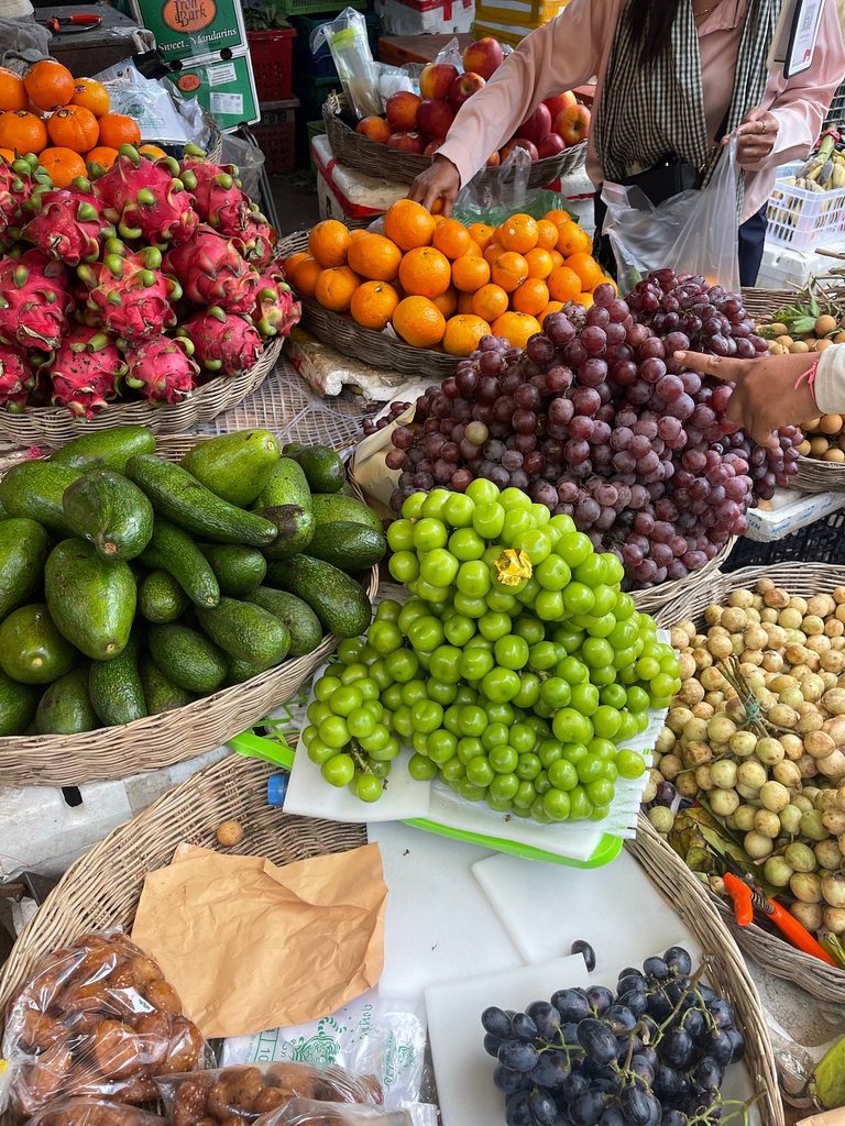 Dragon fruit and tropical fruit piled at a Siem Reap local market stall